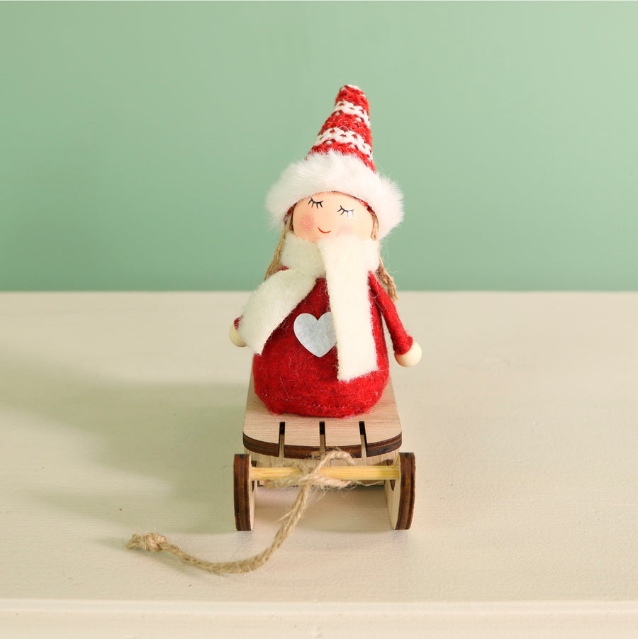 Festive Aurora Doll On A Toboggan
